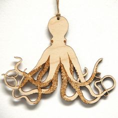 an octopus wooden ornament hanging on a string