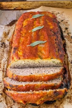 a loaf of meat sitting on top of a wooden cutting board