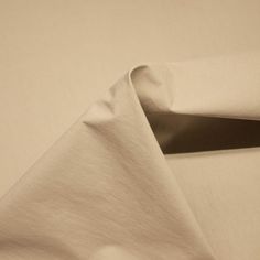 a white sheet is folded on top of a table