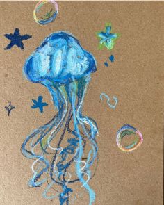 a drawing of a blue jellyfish on brown paper