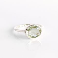 You'll fall in love with the light green coloring of this Green Amethyst Quartz ring. This is a perfectly sized oval to compliment any collection. Popular as a birthday gift for those February babes and Amethyst lovers alike. This is a light, transparent green gemstone with no flaws. This stone is beautifully faceted and bezel set in a 925 sterling silver band or plated with 18k vermeil gold. Gemstone is approximately 8 x 12mm.Band has 925 stamp on inside.Please note that each ring is handmade a Green Amethyst Ring With Oval Shape For Weddings, Green Oval Amethyst Ring For Wedding, Classic Green Amethyst Ring As Gift, Classic Green Amethyst Ring For Gift, Classic Green Amethyst Ring Gift, Green Amethyst Oval Ring For Anniversary, Green Oval Amethyst Ring For Anniversary, Oval Green Amethyst Ring Gift, Oval Green Crystal Birthstone Ring