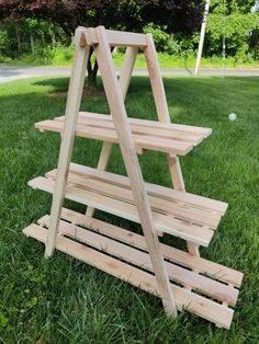 a wooden shelf sitting in the grass