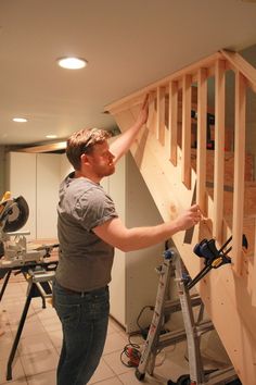 a man is working on some wooden stairs