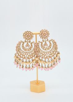 These Polki earrings are a classic addition to any traditional outfit with their stunning stones, crystals, and pearls. They add an exquisite charm and make for the perfect accessory to complete your look. Earrings length: Approx. 3.5" Weight of each earring: 31 gms Push-Back Closure. Antique Gold Plated on high-quality brass as the base metal In-stock & ready-to-ship Color may vary slightly due to light condition & photography. Jewelry Care: Keep away from moisture. Allow perfumes and lotion to Pearl Chandbali Earrings For Receptions, Elegant Chandbali Earrings With Dangling Beads, Elegant Chandbali Beaded Earrings With Dangling Beads, Pearl Embellished Earrings For Festive Occasions, Elegant Jeweled Chandbali Pearl Earrings, Pearl Drop Earrings For Reception, Bollywood Style Jeweled Earrings For Reception, Traditional Pearl Embellished Earrings, Elegant Pink Earrings With Stone Work