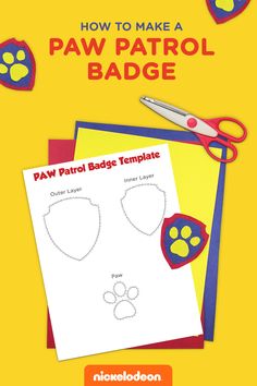 the paw patrol badge is next to a pair of scissors and paper cutouts on a yellow background