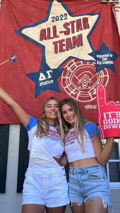 two women standing next to each other in front of a red and blue banner with the words all - star team on it