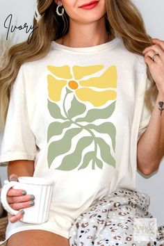 Celebrate your love for nature with our Boho Yellow Daisy Flower Tee Shirt. This botanical tee features a beautiful daisy design, perfect for those who embrace the boho aesthetic. Ideal for gardeners and plant lovers, this wildflower shirt adds a touch of retro floral charm to any wardrobe. Trendy and stylish, it's the perfect addition to your collection or a thoughtful gift for anyone who appreciates the beauty of botanical designs. Affordable Daisy Print Graphic Tee, Trendy Short Sleeve Daisy Print T-shirt, Spring Daisy Print Graphic Tee, White Cotton T-shirt With Daisy Print, Yellow Daisy Flower, Groovy Spring Graphic Print T-shirt, Boho Tees, Botanical Shirt, Cute Graphic Tees