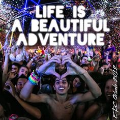 a group of people standing in front of a crowd with the words life is a beautiful adventure