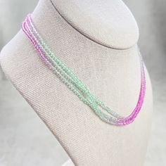 This necklace is made with glass crystal beads which are translucent. The beads are 2mm and faceted. The beads are in ombre coloring from pink to green and back again . Each bead is strung on a micro fused bead thread. Three strands of the beads are attached together for a triple necklace. The necklace is finished off with a gold plated stainless steel chain, clasp and logo charm. The necklace  is 15inches long, a 2inch extension can be added- please let me know in the notes to add one. The necklace is also available in different colors. Ewelina Pas Jewelry Pink Faceted Round Bead Necklaces, Faceted Pink Beaded Necklaces, Pink Faceted Round Beaded Necklaces, Pink Crystal Necklaces With Faceted Round Beads, Pink Crystal Beaded Necklaces, Pink Crystal Necklace With Faceted Beads, Iridescent Crystal Necklace With Faceted Beads For Gift, Triple Necklace, Crystal Beaded Necklace