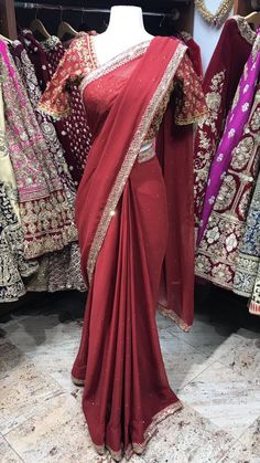 Maroon embroidered saree with stones. Stitched blouses, Peticoat and Fall Beeding included! Blouse style is same for entire order. Blouses are stitched to individual measurements but the shape of the neckline needs to be the same. For example- If you choose a sweetheart neckline all bridesmaids will have a sweetheart neckline but one bridesmaids can have the depth to be 8inches vs. the other can ask the neckline to be 10inches. Final fittings/alterations not included. Fabric - Georgette Our brid Traditional Drape Pre-draped Saree With Dabka Work, Festive Pre-draped Saree With Dabka Work For Diwali, Chinon Pre-draped Saree With Dabka Work, Wedding Blouse With Dabka Work For Eid, Reception Dabka Work Traditional Wear For Festivals, Chinon Saree Blouse For Eid, Festive Semi-stitched Blouse Piece With Dabka Work, Festive Blouse With Dupatta In Chinon, Fitted Pre-draped Saree With Dabka Work For Party