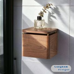 a wooden box with a vase on top of it sitting next to a glass door