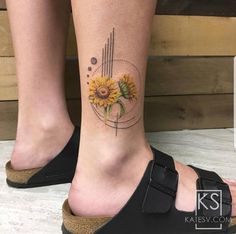 a woman's foot with a sunflower tattoo on it