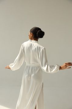 Our long bridal silk robe with wide long sleeves. It could be made of satin or pure mulberry silk. The robe is both casual and elegant, you may wear it on the hen party or spontaneously around your home on a daily basis. It is also an amazing outfit for your vocation, to wear it on the beautiful beach or by the pool as a cover up. -Our model wears size XS, her measurements are 82/61/87 cm and she is 172 cm tall. -Attached with belt. -Arrives beautifully packaged in tissue paper with ribbon -Leng Chic White Wedding Robe, Elegant Kimono With Kimono Sleeves For Brunch, White Long Sleeve Kimono For Brunch, Feminine Long Sleeve Robe For Wedding Night, Chic Robe For Wedding Night And Spring, Chic Long Sleeve Robe For Wedding Night, Elegant V-neck Kimono For Daywear, Long Sleeve Feminine Wedding Night Robe, Satin V-neck Daywear Robe