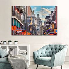 a living room with two paintings on the wall and chairs in front of each other