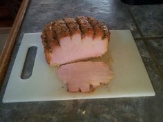 a sliced meatloaf sitting on top of a cutting board