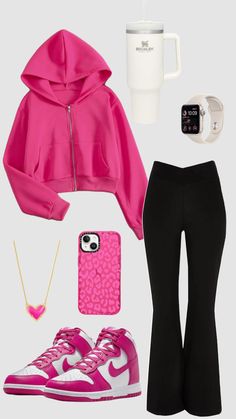 a woman in pink jacket and black pants with cell phone, coffee cup and other items