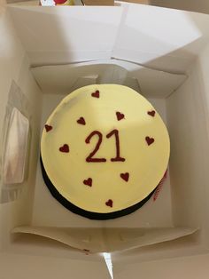 a birthday cake in a box with the number 21 on it