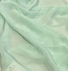 a close up view of a light green fabric