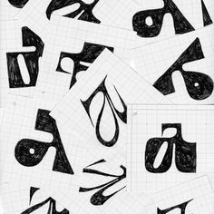 some black and white drawings on paper with scissors in the middle one has been cut into smaller letters