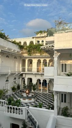 the interior courtyard of an old building with many windows and balconies on each floor