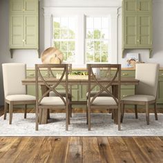 a dining room table and chairs with green cabinets