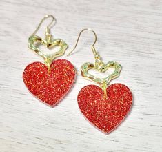 Red glitter dangle heart earrings. Made with lead and nickle free posts. Perfect Valentine's Day gift or accessory. Hang down about 1.5in from ear Will come gift-wrapped. Ships free. Multiple colors available. Red Glitter Earrings For Gift, Glitter Red Earrings For Gifts, Silver Glitter Jewelry For Valentine's Day, Valentine's Day Silver Glitter Jewelry, Heart-shaped Glitter Earrings For Gifts, Glitter Heart Earrings As Gift, Heart Shaped Glitter Earrings For Gift, Heart Shaped Drop Earrings For Valentine's Day, Heart-shaped Drop Earrings For Valentine's Day