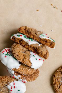 cookies with white icing and sprinkles are stacked on top of each other