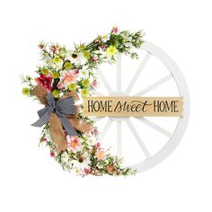 a wooden wheel with flowers on it and a sign that says home sweet home