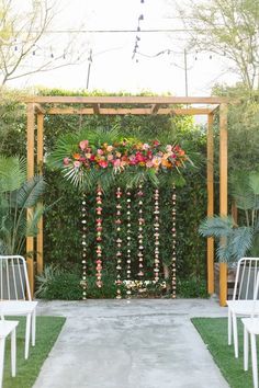 an outdoor ceremony setup with flowers and greenery