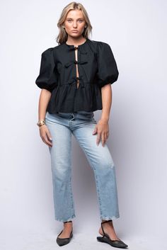 Elevate your everyday look with our Carmine Blouse. This puff sleeve blouse boasts delicate tie details on the front, adding a touch of elegance. The ruffle hem adds a feminine flair! 100% Cotton Hand Wash Cold Import Fit Guide: Hannah is 5ft 5 inches, Bust 32”, Waist 25”, Hips 29” Model is wearing a size small True to size *Available at our Envy location Chic Cropped Blouse With Gathered Sleeves, Spring Black Puff Sleeve Top With Ruffles, Black Ruffled Puff Sleeve Top For Spring, Chic Spring Puff Sleeve Top With Tie Sleeves, Black Puff Sleeve Top With Ruffles For Spring, Cropped Blouse With Tie Sleeves, Chic Blouse With Ruffle Hem For Daywear, Casual Blouse With Puff Tie Sleeves, Chic Black Puff Sleeve Top With Ruffles