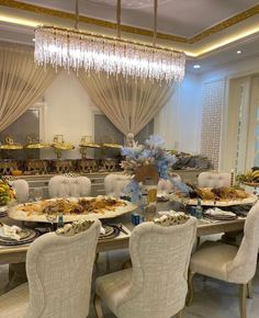 a dining room table set with plates and chairs