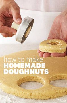 a person is making homemade doughnuts on a table