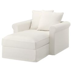 a white chair with two pillows on it