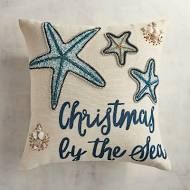 a decorative pillow that says christmas by the sea