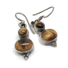 Very Unusual Tiger Eye Bali Silver Drop Dangle Vintage Hoop Earrings Lovely vintage drop dangle earrings with Tuger Eye Stones.   Measures 3.3 cm by 1 cm see the photos at the end against a ruler.  In fine vintage condition  🎀Thank you so much for looking🎀 Please don't miss my other items in this shop: https://www.etsy.com/uk/shop/PoshGemz *Please note I don't add boxes it makes postage expensive  (Unless it is a box that is bespoke to the item) Your items  will come wrapped carefully and usua Brown Sterling Silver Drop Earrings, Brown Sterling Silver Dangle Jewelry, Bali Silver, Eye Stone, Tiger Eye, Vintage Earrings, Uk Shop, Favorite Jewelry, Jewelry Earrings Dangle