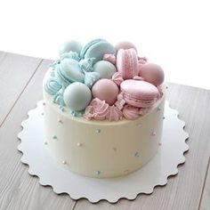 there is a cake with macaroons on the top and frosting around it