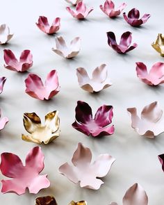 many pink and gold flowers on a white surface