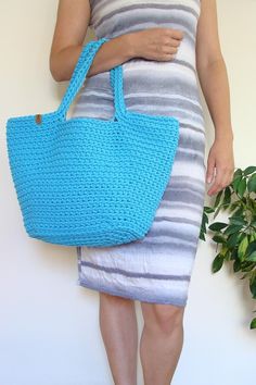 Boho chic, this crochet bag is irreplaceable during summer. This classic basket shape purse is ideal addition to flimsy dress or to short or long jeans, t-shirt and sweater. Either as a summer accessory, as a beach bag or everyday bag - it's comfortable in using. Roomy enough to fill it with books, beach stuff, kid's stuff or groceries. Perfect as a gift too! Summer Cotton Bucket Shoulder Bag, Cotton Bucket Shoulder Bag For Beach, Handmade Cotton Beach Bag For Summer, Handmade Casual Crochet Bag For Beach, Trendy Crochet Beach Bag For Summer, Casual Cotton Beach Bag With Braided Handles, Casual Handmade Crochet Bag For Beach, Casual Handmade Tote Beach Bag, Cotton Straw Tote Bag With Braided Handles