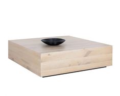 a black bowl sitting on top of a wooden box