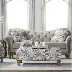 a living room scene with focus on the couch and ottoman