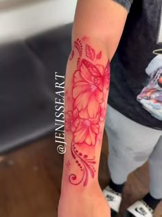 a person with a flower tattoo on their arm