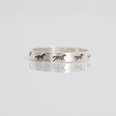 If you are looking for a unique,  beautiful, sturdy and horse themed stacking ring, look no further! These hand crafted rings are custom made to order with horses running around the band.  Available in your choice of metal and ring size. *Metal choice of Sterling Silver, Rose Gold Filled or 14k Gold Filled *Available in sizes 3 to 14 (including half sizes) *The band is 3mm wide and 1mm thick *PLEASE NOTE: This listing is for only one of the rings in the photo. Choose from the paw print ring or the cat ring in the drop down options. *14k Gold Filled and Rose Gold Filled will have noticeable solder joints since there is no rose filled or gold filled solder so it will be sterling silver solder. You will see the solder joints on the back since they are hand soldered by me, as hard as I try for Horse Rings, Paw Print Ring, Horses Running, Horse Ring, Lover Jewelry, Running Horses, Cat Ring, Earring Holder, Cat Jewelry