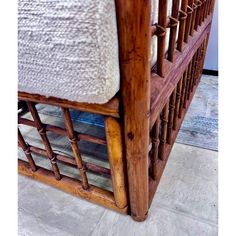 a bamboo bed frame with white linen on top