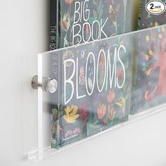 there is a sign that says big book blooms in front of some books on the wall