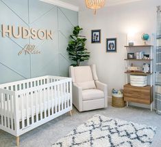 a baby's room with a white crib and blue walls