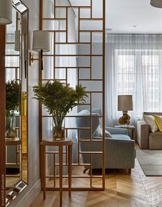 a living room filled with furniture and a large mirror on the wall next to a couch