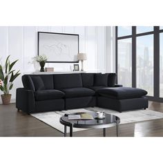 a living room with a large black sectional couch