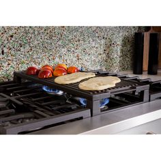 two pita breads sit on the burners of an electric stove in a kitchen