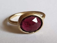 "Beautiful solitaire garnet ring, boho oval gemstone jewelry for women, available in 14k gold plating, sterling silver, 9k yellow gold, or 14k yellow gold.  This statement handmade gold ring is set with a natural oval faceted garnet. It is available in high-quality 14k gold plating, sterling silver, 9k yellow gold, or 14k yellow gold.  Garnet is January's birthstone, making this ring a great gift option for yourself or a loved one with a January birthday. The gem's color blends seamlessly with t Oval Garnet Signet Ring With Gemstone, Oval Garnet Gemstone Signet Ring, Handmade Oval Ruby Ring Fine Jewelry, Handmade Oval Ruby Ring In Fine Jewelry Style, Handmade Oval Ruby Ring In Yellow Gold, Handmade Oval Sapphire Ring In 14k Gold, Handmade 14k Gold Oval Ruby Ring, Handmade Oval Ruby Ring In 14k Gold, Handmade Gold Oval Amethyst Ring