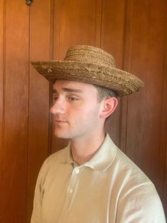 Straw Panama Hat. Men's Vintage Straw Hat. The rim of the hat is 15 inches long and 14 inches across. It has a band that appears to be an African fabric. The yellow, black, green and red colors are still vibrant. It is made of woven straw and is in good condition, but some of the ends of the string are visible where the end stitch was done. There are no labels inside. It can be worn by a man or woman. The crown is oval and 8 inches long x 7 inches wide. The hat is 4 inches tall. This came from t Adjustable Flat Cap For Beach, Vintage Flat Cap Hats For Summer, Brimmed Costume Hats For Country Events, Wide Brim Summer Top Hat, Western Style Adjustable Flat Cap, Fitted Natural Hat Band, Wide Brim Natural Boater Hat, Vintage Brimmed Panama Hat For Country Events, Adjustable Western Style Flat Cap